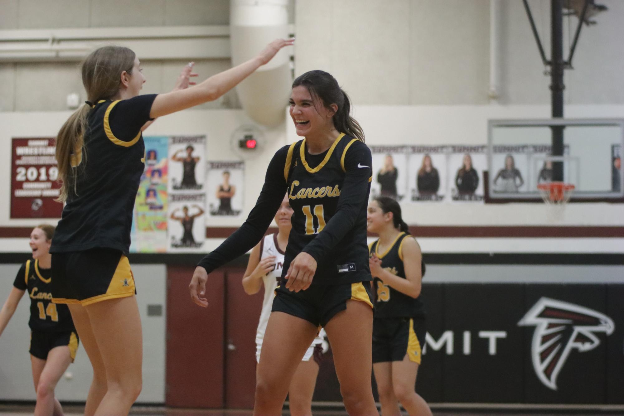 Senior Taylor Nania celebrates after scoring a free throw against Rockwood Summit. That score marked her 1000th high school career point. Before the game, Nania said scoring her 1000th point will be like a reward for all her hard work. 