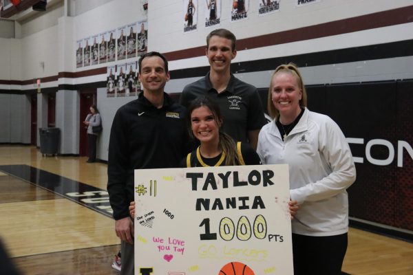 Senior guard Taylor Nania poses with coaches after scoring 1000 career points.
The Lancers won the game, 46-36, over the Falcons, Monday night.