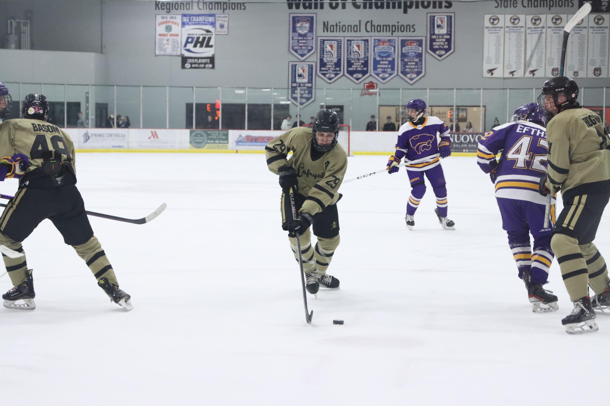 Senior forward Mack Freeman carries the puck in the Battle of 109 hockey game against Eureka. 