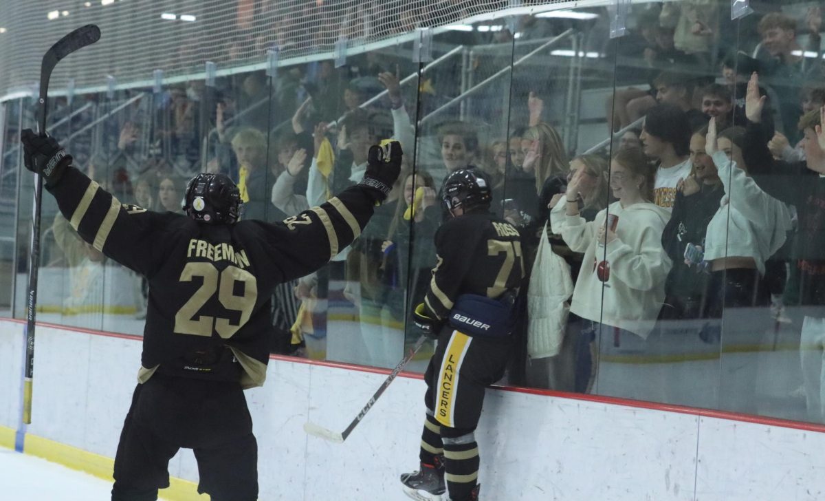 Forwards Mac Freeman and Lucas Ross celebrate after a Lancer goal.