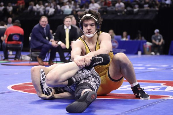 Sophomore wrestler Carter Brown holds the leg of Willard wrestler Porter Talbot in the State semifinal match. This was a rematch of the Winnetonka final that Brown won to claim first place over Talbot in January.