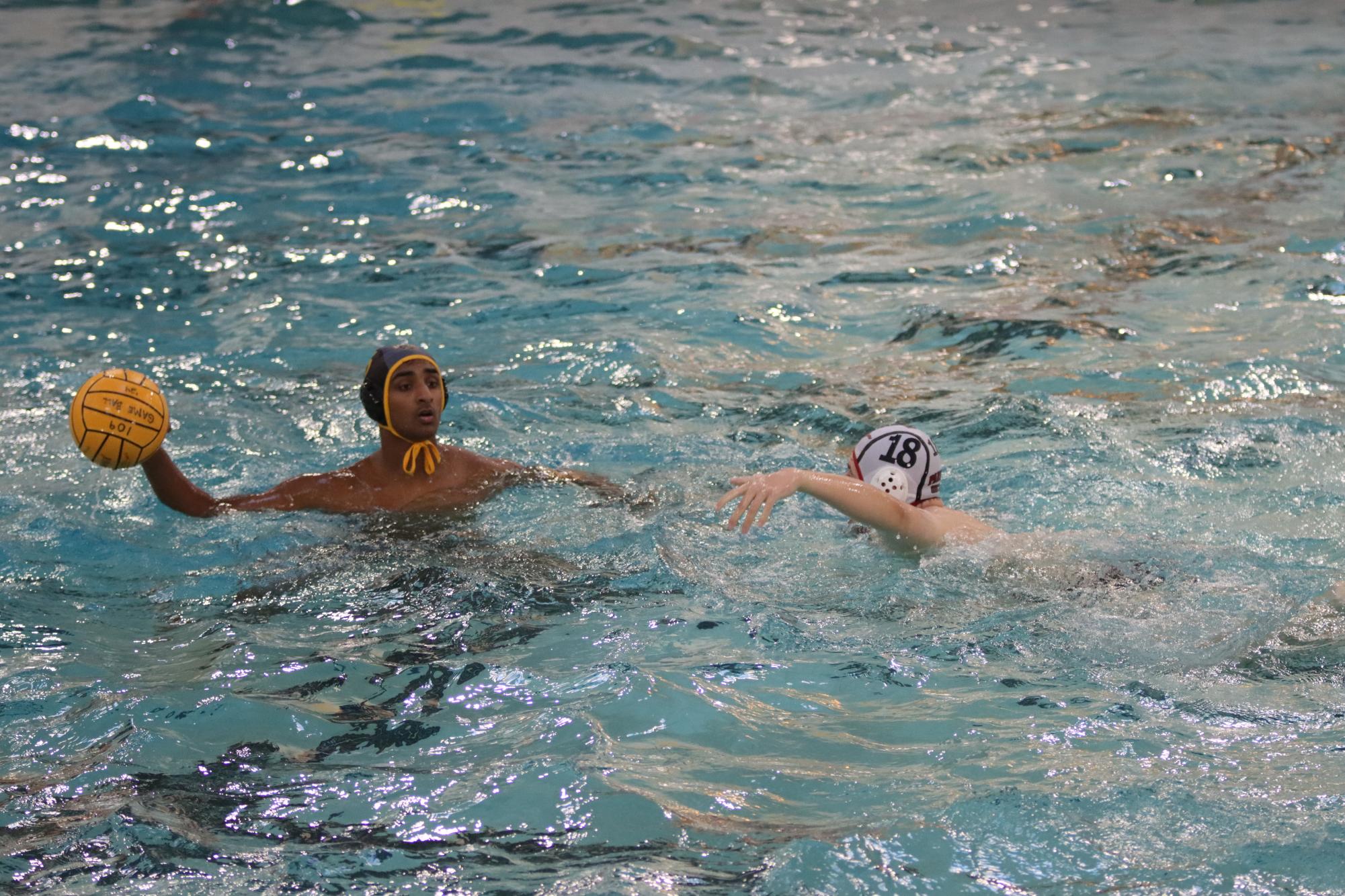 Senior utility Sreeram Manchikalapudi extends his arm to pass the ball. Manchikalapudi was noted a key player to watch this season by boys water polo head coach James Waeckerle.