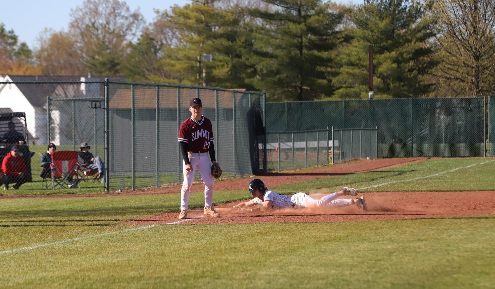 Sliding into third base, senior centerfielder Michael Callahan moves into scoring position during their 11-5 loss to Rockwood Summit April 15. The Lancers lost both games in their series with the Falcons.