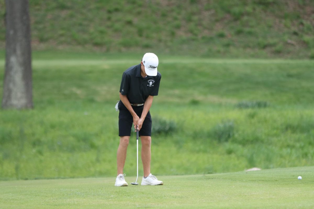 At St. Albans Golf Course, junior Austin Rinkenberger sets up to putt. Rinkenberger shot 4 under par to help Lafayette win by 18 strokes over Marquette. 