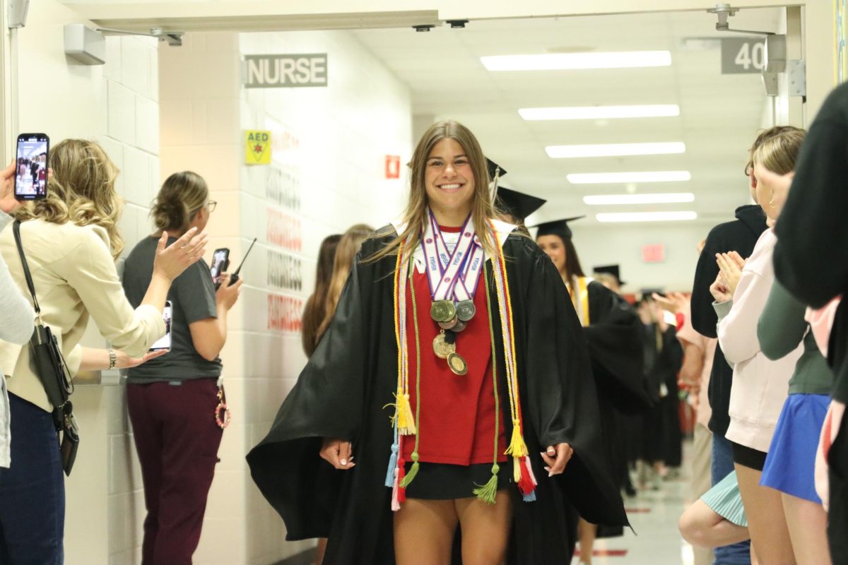With a smile on her face, senior Avery Brown walks down a hallway at Rockwood Valley Middle School. On Friday, May 9, the class of 2025 visited their elementary and middle schools before graduating.