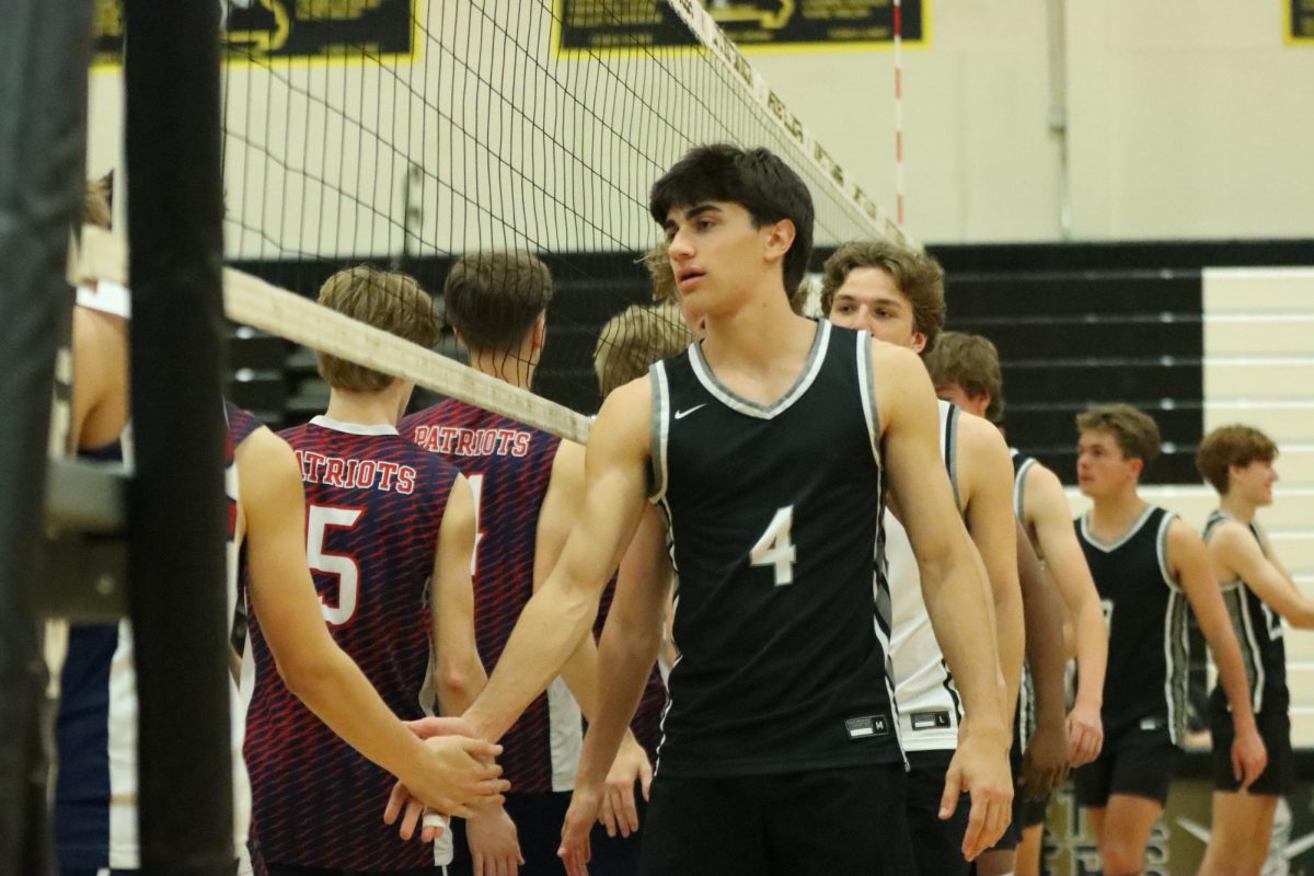 Walking across the net, senior Charlie Caby and the boys volleyball teamshake hands with the Parkway South team. The Lancers bested the Patriots 4-1 at Lafayette, Thursday, May 1.