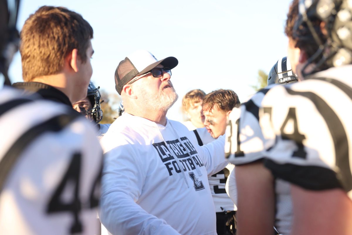 Looking up, coach Boyd Manne talks to the football team during Lafayette's State quarterfinal win over Cardinal Ritter, Saturday, Nov. 23, 2024. The Lancers dethroned the defending State champions 30-18.