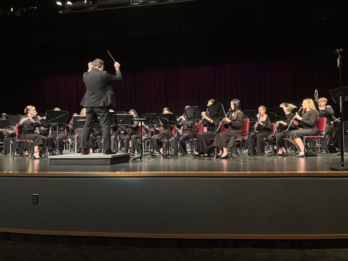 Music teacher Brad Balog directs the Wind Ensemble through one of their pieces, "One Life Beautiful" by Julie Giroux.