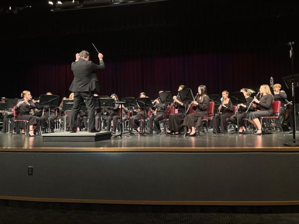 Music teacher Brad Balog directs the Wind Ensemble through one of their pieces, "One Life Beautiful" by Julie Giroux.