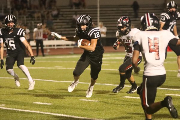 On Aug. 20, 2024, junior running back Cody Keen drives the ball downfield against Parkway Central. The Lancers won 58-0.