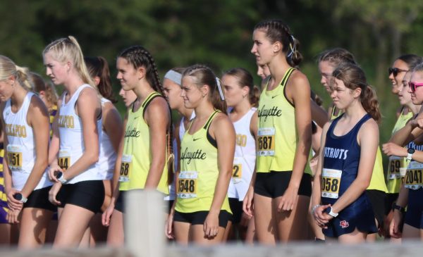 Junior runners Kelly Archambeault and Alexis Sandberg and sophomore runner Marli Groenewald stand together before competing at the Gans Creek Invitational, Sept. 28, 2024. All three runners were mentioned as athletes to watch this season.