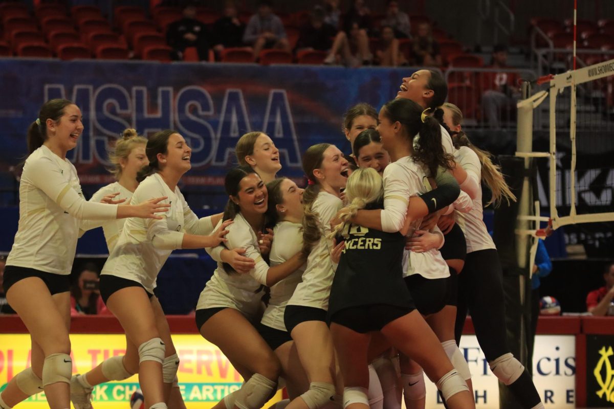 Volleyball players celebrate after their state championship win against Ozark, Nov. 7, 2024.
