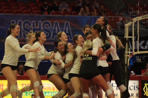 Volleyball players celebrate after their state championship win against Ozark, Nov. 7, 2024.