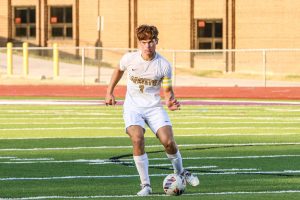 During the Battle of 109, senior center defender TJ Bender dribbles down the field. Bender led his team to squeeze out a 3-2 win against the Wildcats.