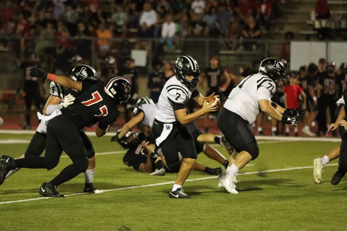 To avoid a sack, senior quarterback Brady Micek escapes the pocket and rushes downfield. Micek threw for 245 yards and four touchdowns, as Lafayette beat Parkway Central, 55-0. 