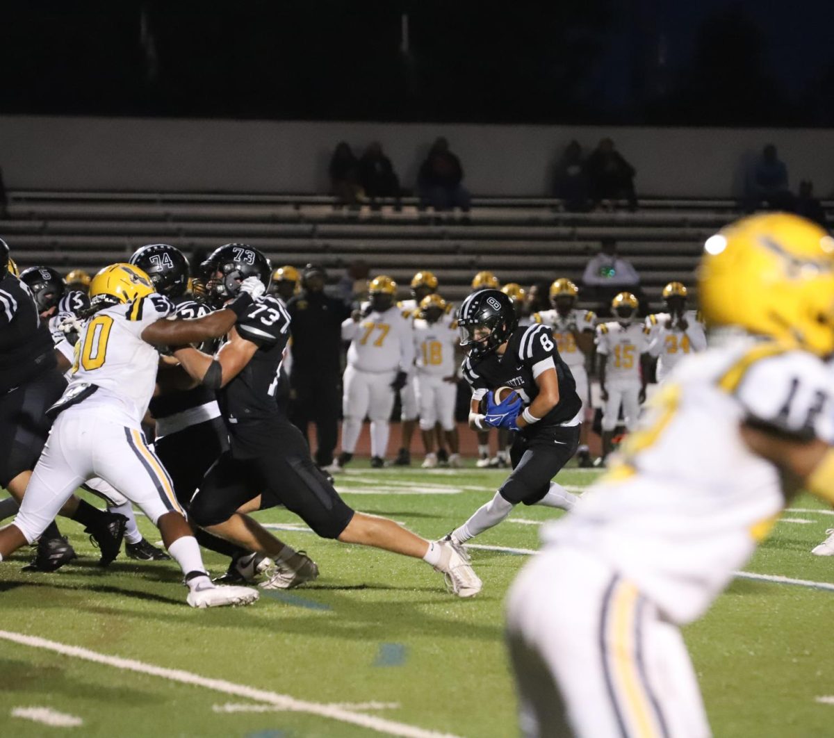 Rushing the ball, junior wide reciever Cody Keen looks to gain yardage during a play.