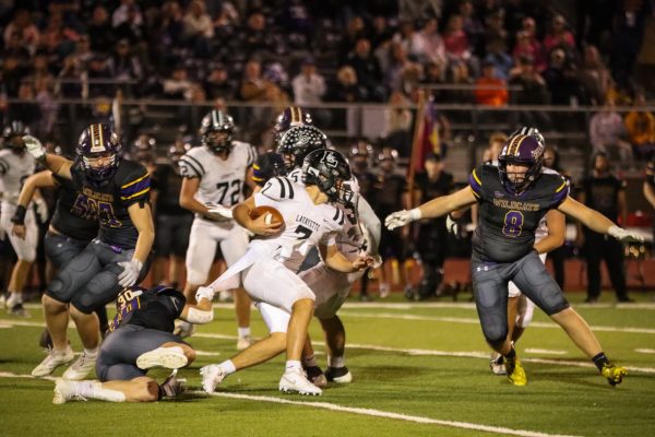 To avoid a sack, senior quarterback Brady Micek rushes out of the pocket, making a positive play. Micek led Lafayette to win over rivals Eureka in the Battle of 109 with his 241 passing yards and 80  rushing yards. 