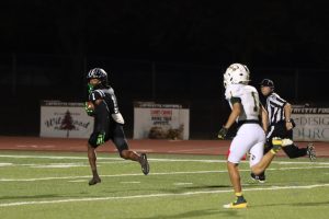 After recieving senior quarterback Brady Micek's pass, senior wide receiver Tim Washington runs the ball into the end zone on the first play of the game. Lafayette defeated Lindbergh, 54-14, on senior night Friday Oct. 17.