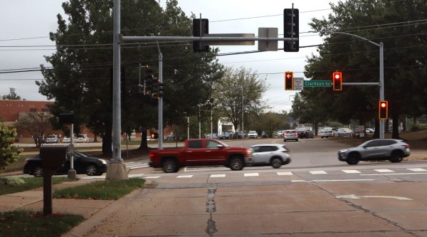Cars pass one muggy morning outside of Marquette High School, October 7, 2025