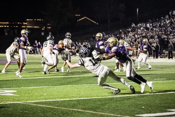 To get a first down, senior wide receiver Zachary Toben attempts to catch a pass form senior quarterback Brady Micek. 