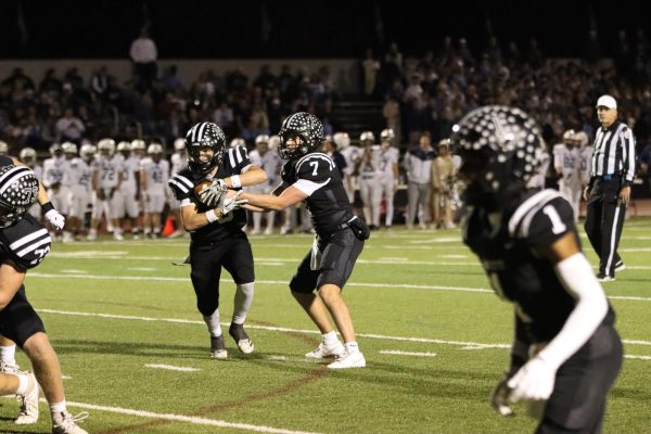 During the Class 6 District 2 Semifinal, senior quarterback Brady Micek hands off the ball to junior running back Cody Keen. With 87 yards, Keen led team in rushing yards and scored a touchdown to help Lafayette beat SLUH, 28-25.