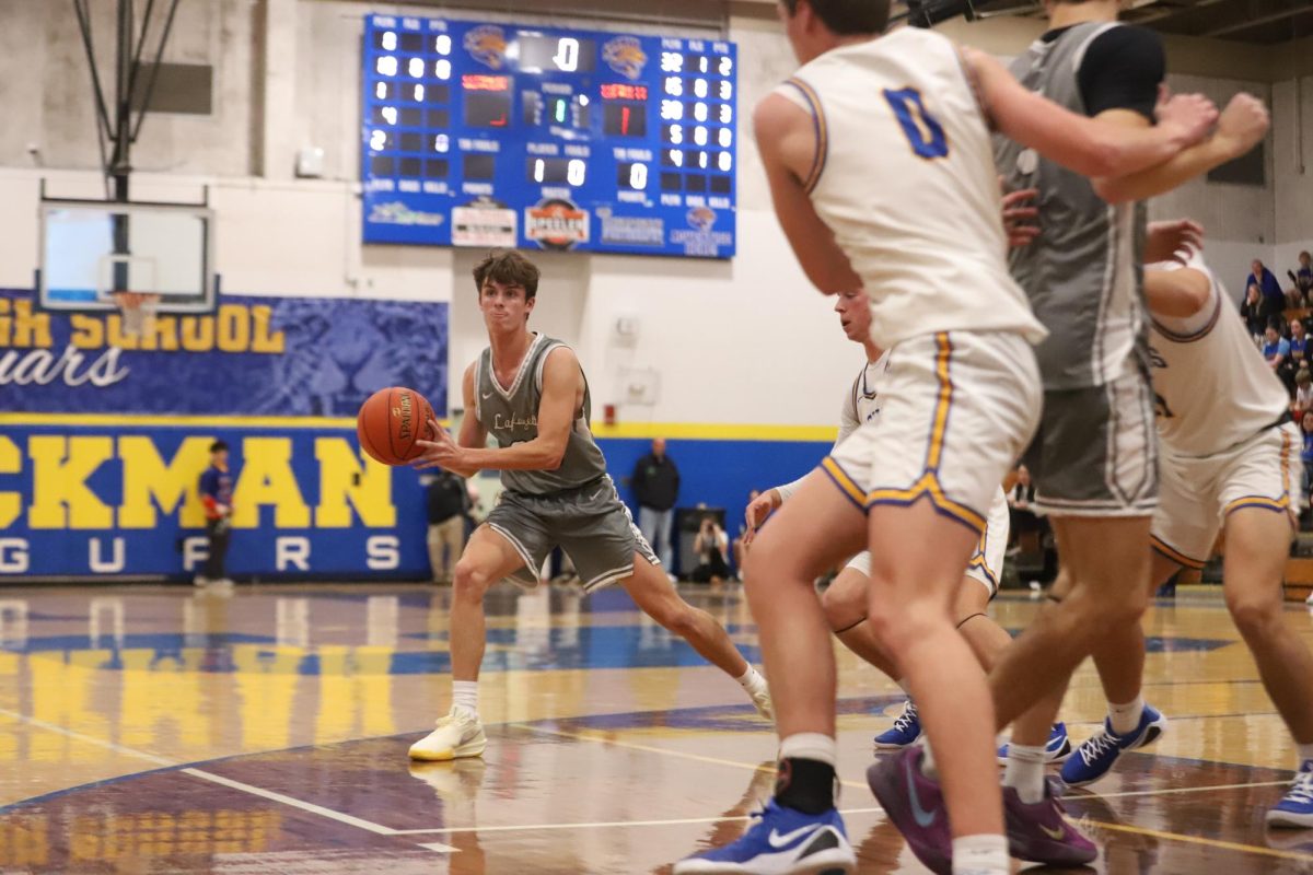 In the first half of the game, senior guard Cooper Myers prepares to pass the ball to a teammate. Lafayette defeated Seckman, 53-48, in their season opener on Tuesday, Nov. 25.