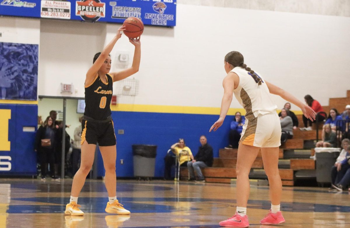 On offense, junior guard Maria Golfo prepares to make a pass. Golfo led the team in assists, earning three on Tuesday.
