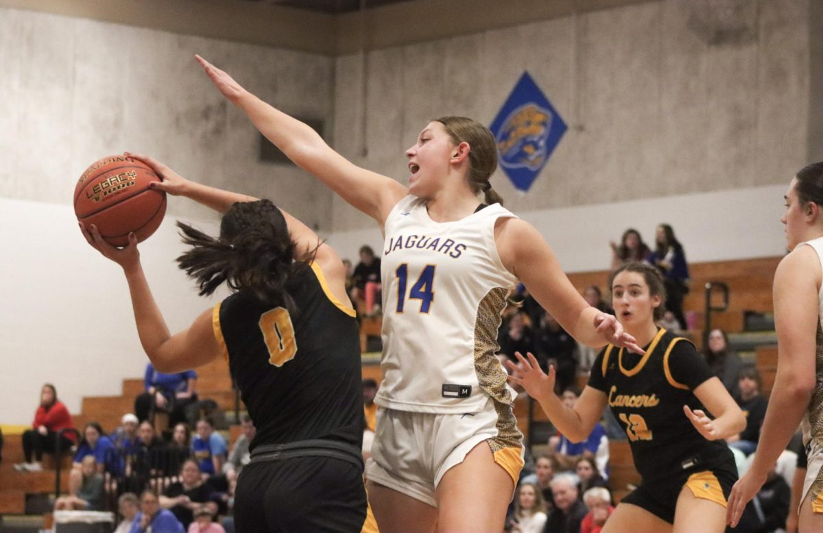 Dodging a block, junior guard Maria Golfo prepares to pass to junior forward Annie Kirtley. "We came up pretty well, so it gave us hope for the rest of the season," Kirtley said after the Lancers' victory.