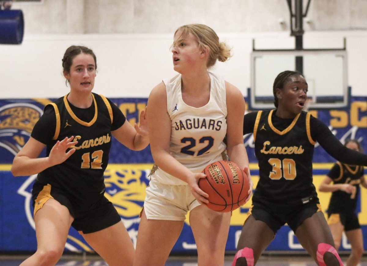 Defending their court, junior forward Annie Kirtley and sophomore guard Jasmyn Callaham flank their opponent. "We did a good job shutting them down," Kirtley said after the game. "We had a lot of strategy going into defense."