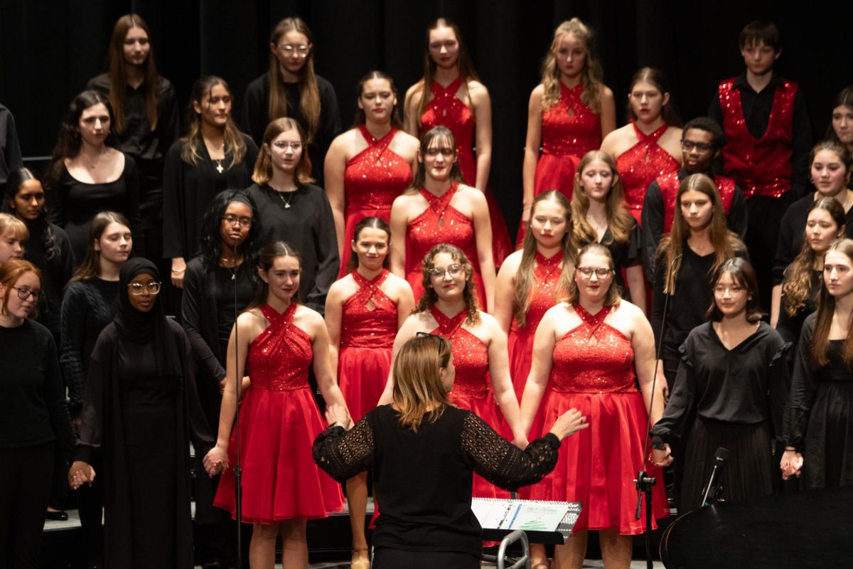 Choir teacher Christy Shaffer conducts a combined school choir on December 9, 2025.