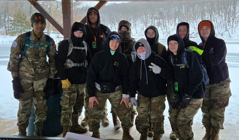 With eight inches of snow on the ground, Orienteering members (front row, from left), junior Siddharth Muddhana, junior Cole Kirberg, senior Jacob Ward, senior Andrea Olsen, junior Savannah Marta; (back row) junior Tej Atwal, sophomore Deagen Mclaughlin, junior Sydney Helm, junior Jamie Olsen, junior Zoe Lampman pose for a picture before the “Tame the Dragon” event at Lake of the Ozarks State Park, Feb. 22, 2025.