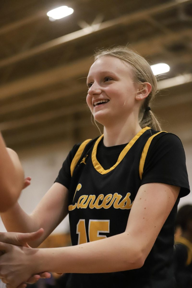 During the lineup announcement, freshman guard Peyton Cunningham does a handshake with a teammate. Cunningham had four rebounds against the Jaguars.