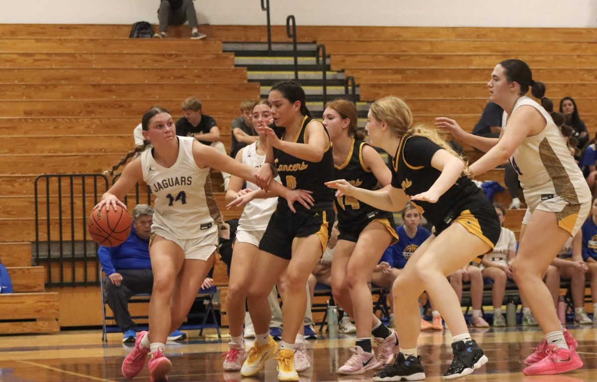 From left: Junior guards Maria Golfo and Isabelle Hrdlicka and senior forward Annika Kivisikk block their opponent. "We played hard. Our defense was really good," Golfo remarked.