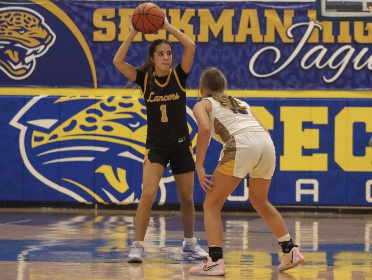 Face hardened in focus, junior guard Lylah Kimberlin looks for a teammate to make a pass. "Our team chemistry was good," Kimberlin reflected. "We played really well together."