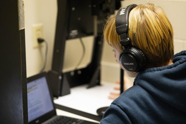 Podcast Club member Adam Paciorek reads from a script on Monday, Jan. 12.