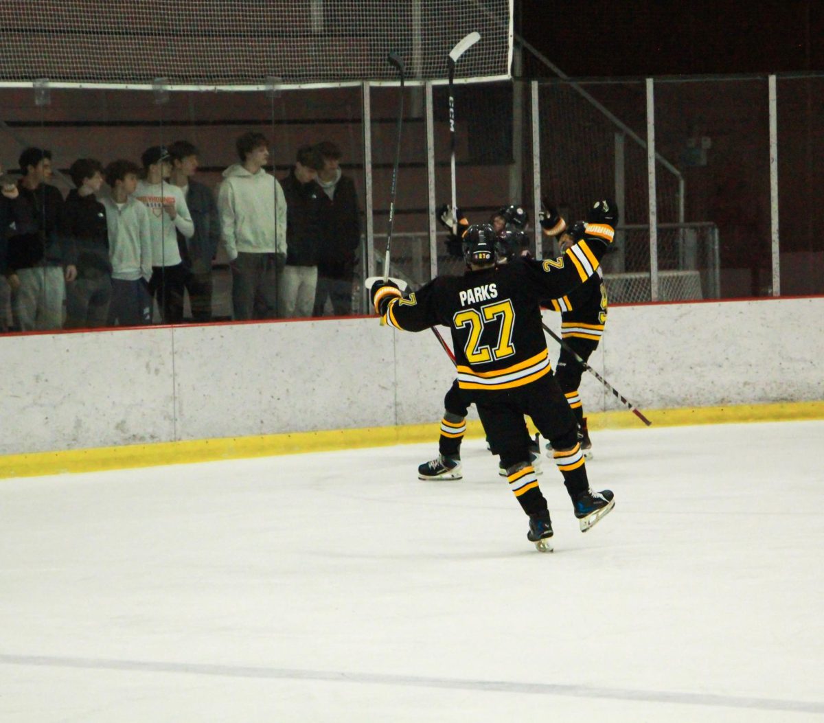 Balancing on one foot, junior defenseman Quentin Parks celebrates a successful first period. "After our big win against Clayton, we're going to keep bringing that same energy and effort into upcoming games," junior defenseman Sean Dean said. Dean is not pictured.