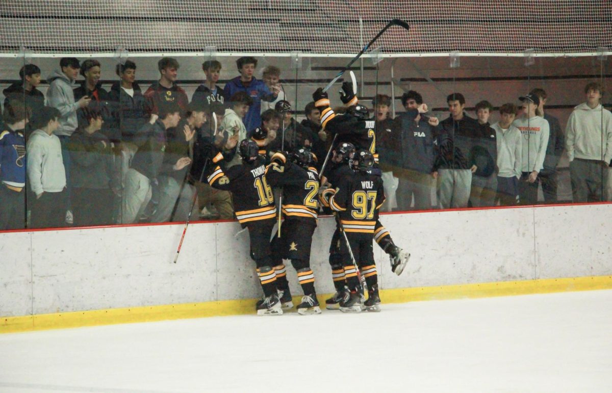 From left: Forward Quinn Thomas, defenseman Quentin Parks, forward Vincent Wolf and defenseman Kellen Moore celebrate after a goal. "The team played great," coach Jim Carrico said. "They're really coming together."