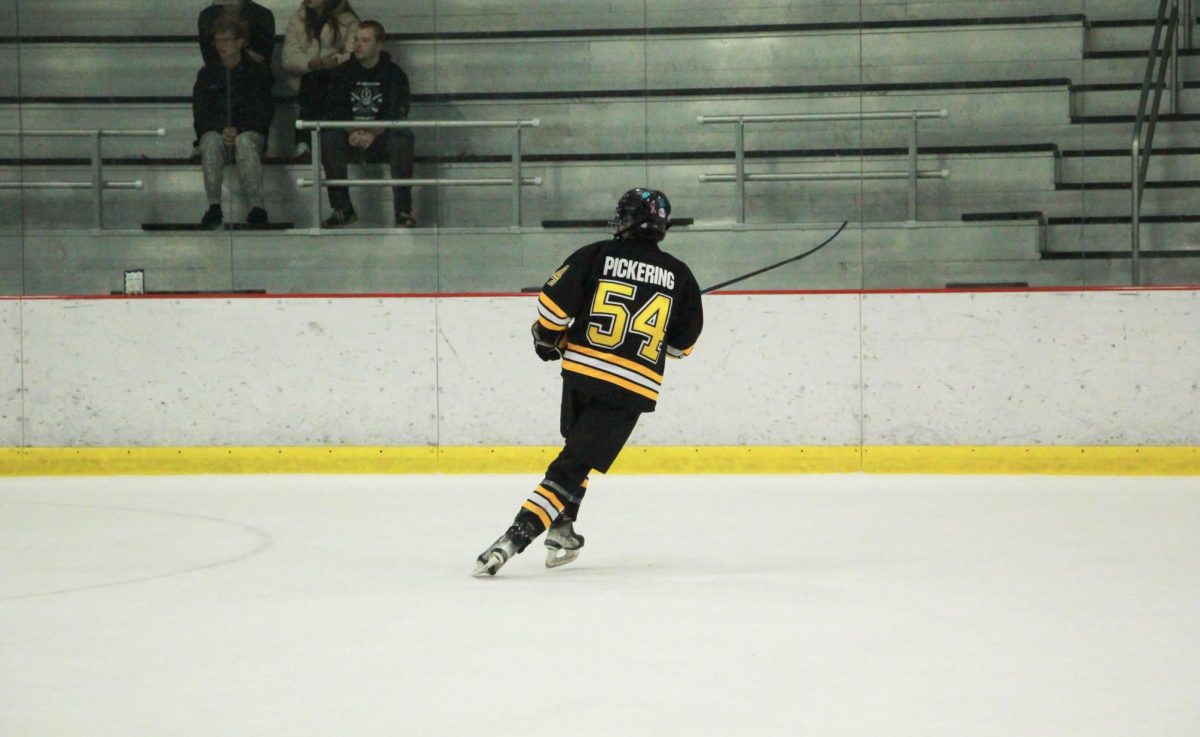Gliding, freshman defender Lucas Pickering skates toward the offense. Pickering brought the Lancers' lead to 5-1 with a goal late in third period. 