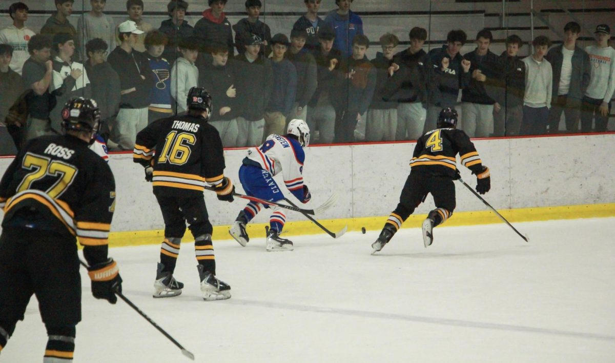 Sophomore forwards Luke Ross and Quinn Thomas watch as freshman defenseman Jackson Ridgeway guards an opponent. "The [Lafayette] boys were just buzzing," Ross said.