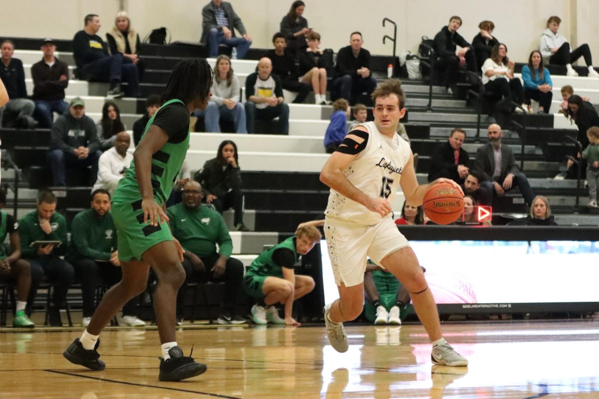 With ball in hand, senior forward Drew Pickering drives into the paint. Pickering helped the Lancers win 67-57, Tuesday night.