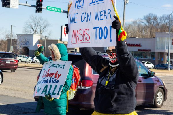 Amy Minton and another protester hold up signs protesting Ann Wagner and the Trump administration on Sunday, February 22.