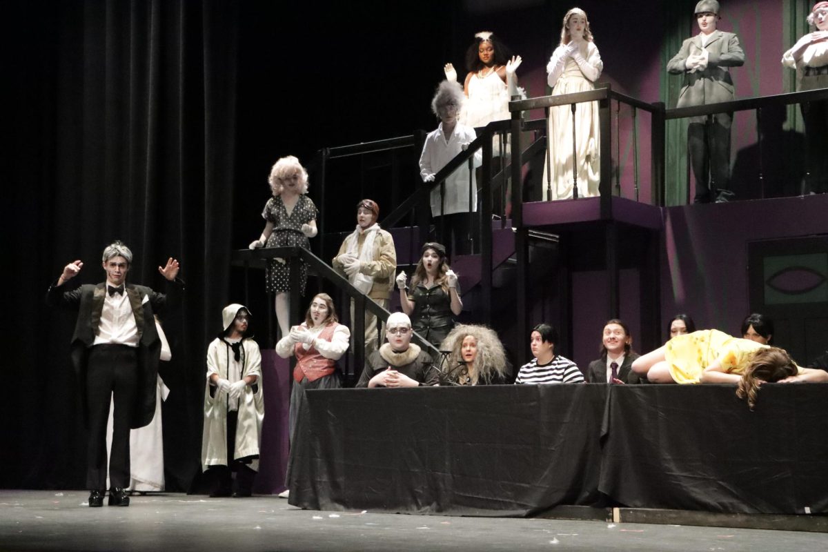 As a final preparation for the winter musical “The Addams Family,” LTC performs in front of middle school students on Wednesday, Feb. 4 during lunch time in the Theatre. “The musical was based around the Addams family and their troubles after Wednesday Addams falls in love with a boy from Ohio that is vastly different from the family. Lucas Beineke and his parents, Mal and Alice, are as normal as can be and they struggle to understand the Addams and their way of life. The musical follows the two families as they struggle with secrets, love, and understanding each other,” said senior cast member Lucas Niblett. 