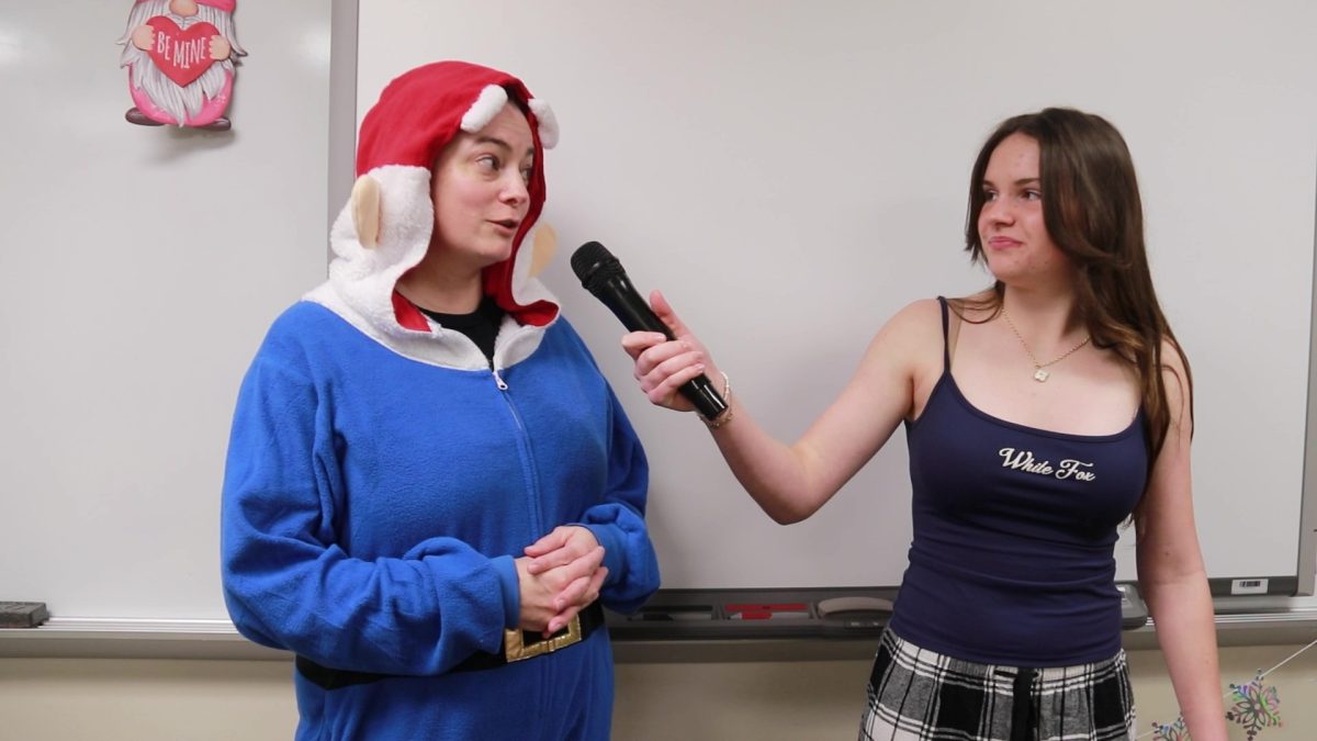 FACS teacher, Lauren Arnet, tells freshman, Kat Warren, about her spirit day outfit.