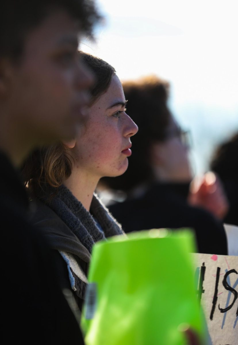 After walking back to Lafayette, sophomore Zoe Faw stands and looks to the street, preparing to continue protesting. "It wasn't hard for me to decide [to go] mainly because doing whatever we can to help and protect each other is so much greater than any punishment the school would have given us," Faw said.
