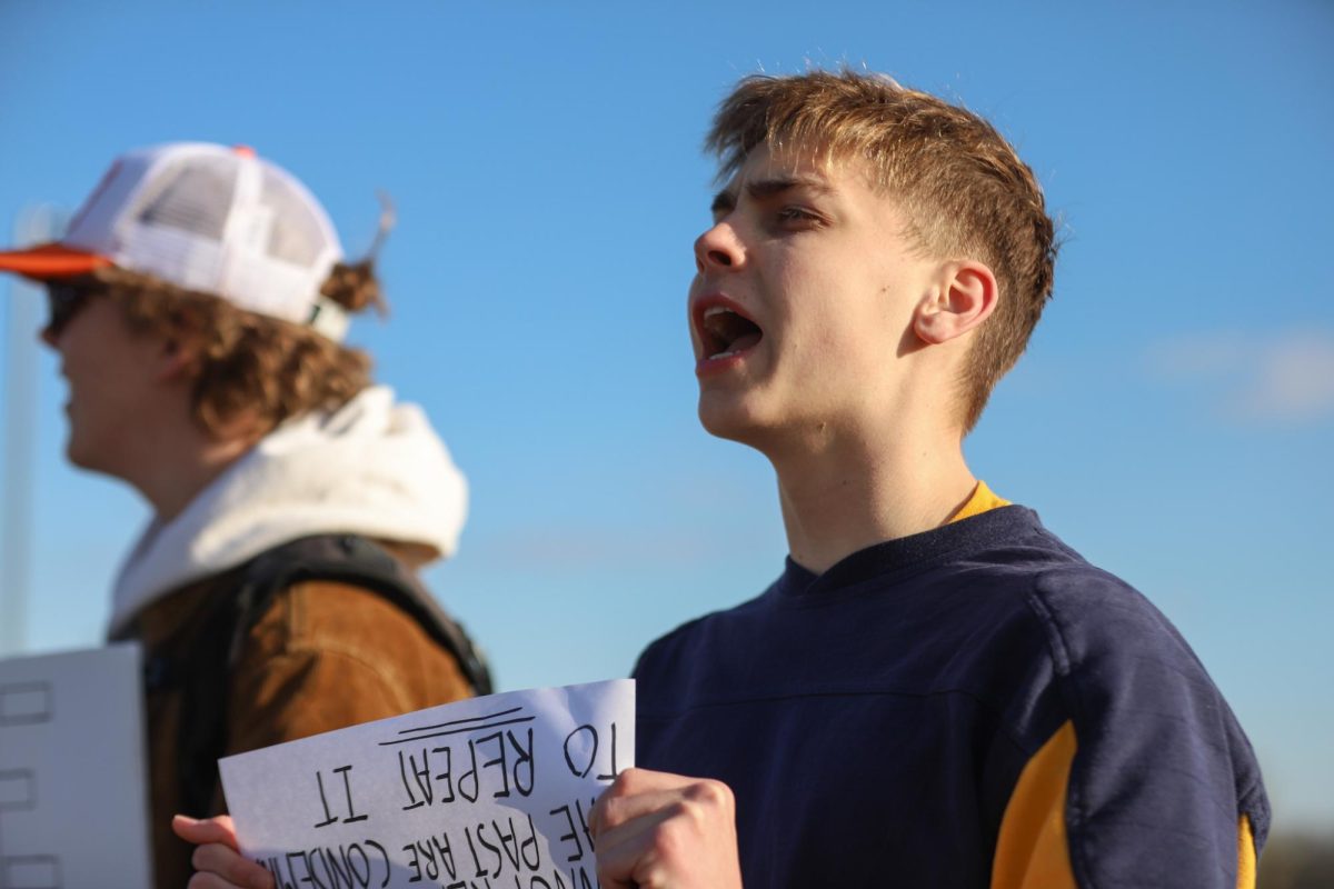 Once school ended, junior Ambrose Fischer quickly joined the protesters to show his support. Fischer held a sign that read "Those who cannot remember the past are condemned to repeat it."