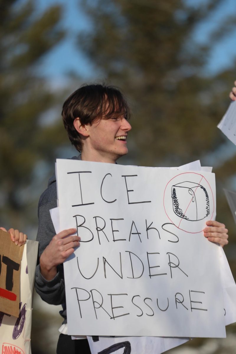 Facing the Lafayette parking lot, senior Alastair Hanna holds up a sign that says "ICE breaks under pressure." "The walkout was the most fun I've had in a long time...it was an amazing experience that brought me closer to Lafayette's community, even if the group seemed relatively small," Hanna said. 