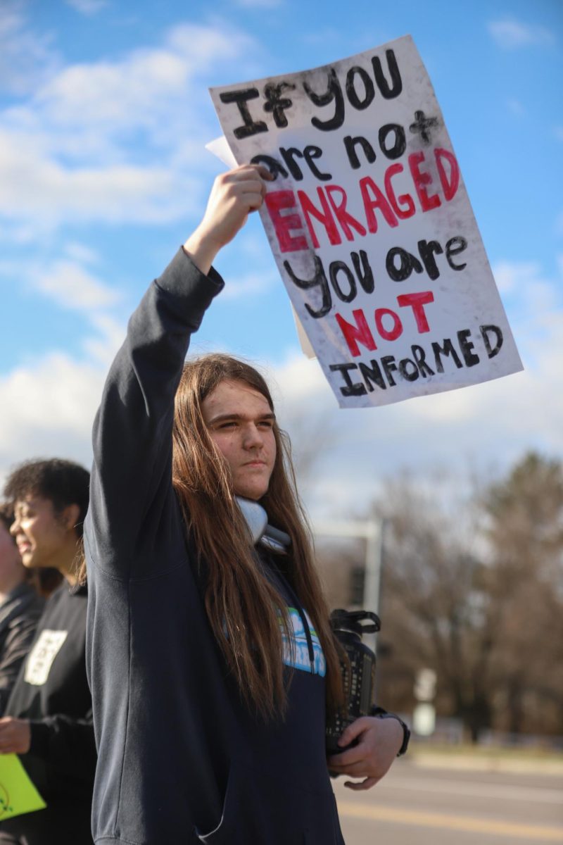 After the walkout, junior Liam Tockman continued protesting with the group in front of Lafayette. His sign said "If you are not enraged, you are not informed." "The reason I made that sign was this administration is fostering this world of anti-intellectualism, where people are feeding into media that is not representative of the truth. So, if you're not enraged by seeing people being kidnapped and killed, then you are not informed," Tockman said.