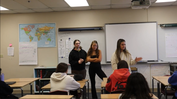 Mock trial co-captains, Zoe Lampman, Ariana Totakhil, and Natalie Bolla, describe their agenda to the club's members