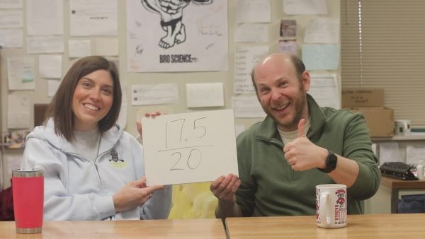 Language arts teachers, Katie Shea and Jeff Landow, showcase their score from the vocabulary guessing game.