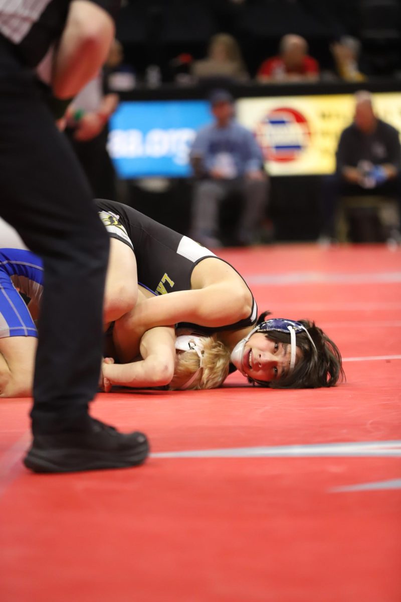 With his head flat on the mat, junior Caleb Frankenberger looks up at the referee as he prevents sophomore Carson Owens of Seckman High School from escaping. 